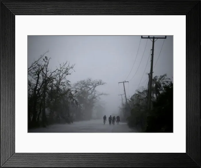 Framed Print : People walk on the road as rain falls during Hurricane Matthew in Les Cayes, Haiti Framed Print : People walk on the road as rain falls during Hurricane Matthew in Les Cayes, Haiti