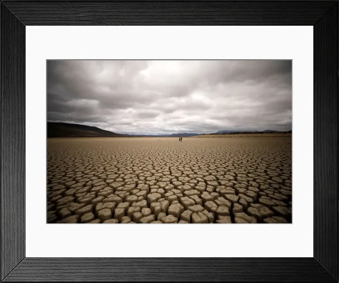 Framed Print : Clouds gather but produce no rain as cracks are seen in the dried up municipal dam in Framed Print : Clouds gather but produce no rain as cracks are seen in the dried up municipal dam in