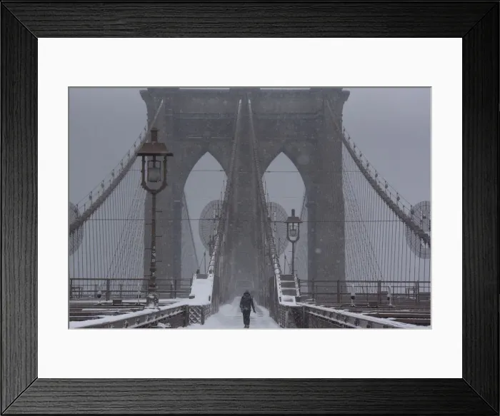 Framed Print : A person walks over the Brooklyn Bridge during winter storm Niko in New York City Framed Print : A person walks over the Brooklyn Bridge during winter storm Niko in New York City