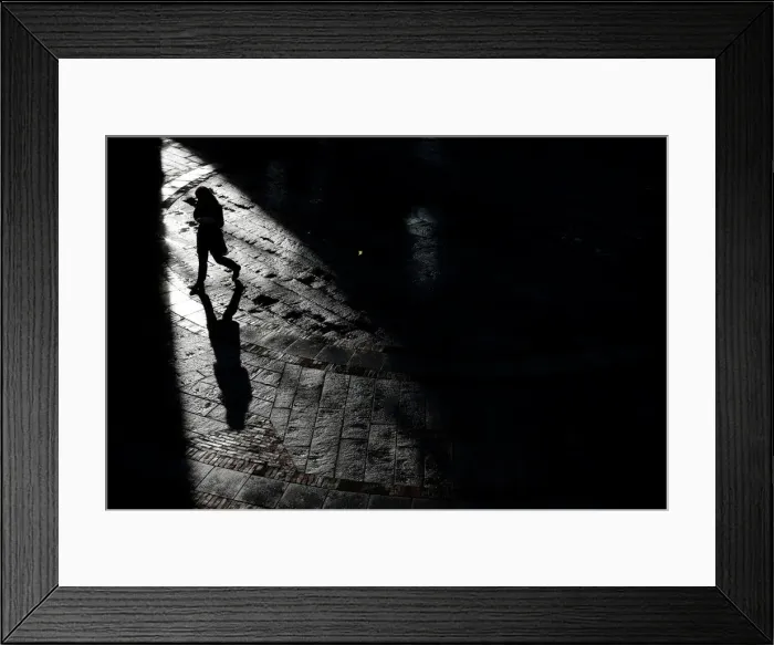 Framed Print : A pedestrian walks through Quincy Market on a warm winter afternoon in downtown in Boston Framed Print : A pedestrian walks through Quincy Market on a warm winter afternoon in downtown in Boston