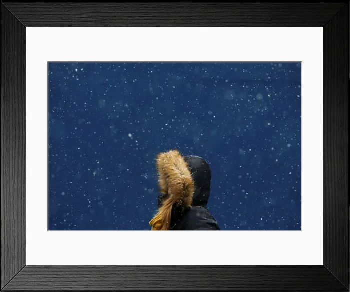 Framed Print : A woman walks in the snow at Times Square in New York Framed Print : A woman walks in the snow at Times Square in New York