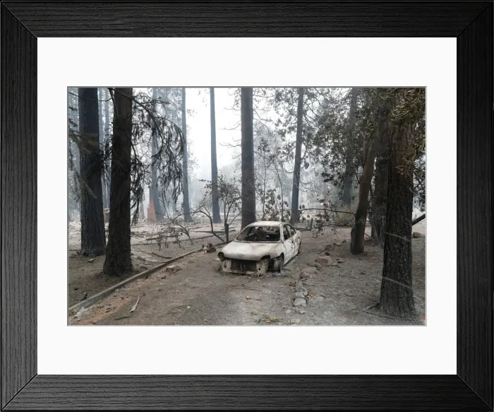 Framed Print : A car destroyed by the Camp Fire is seen in Paradise
