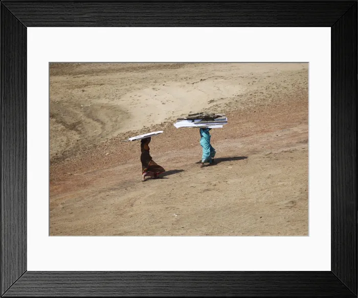 Framed Print : Women carry pieces of a temporary roof to rebuild their houses after Cyclone Phailin hit Framed Print : Women carry pieces of a temporary roof to rebuild their houses after Cyclone Phailin hit