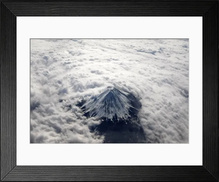 Framed Print : Japans Mount Fuji, covered with snow and surrounded by cloud, is seen from an airplane Framed Print : Japans Mount Fuji, covered with snow and surrounded by cloud, is seen from an airplane