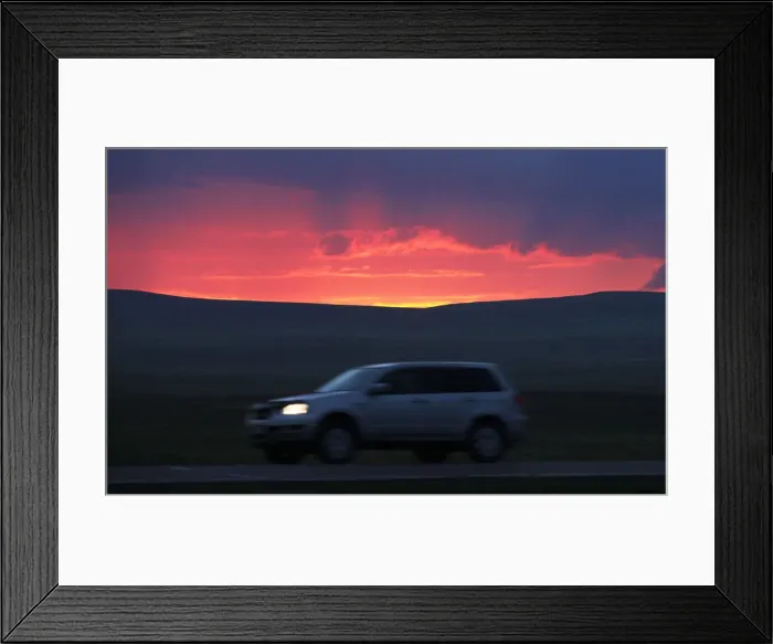 Framed Print : A motorist drives along a highway during sunset south of Russias Siberian city of Framed Print : A motorist drives along a highway during sunset south of Russias Siberian city of