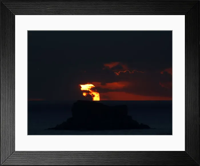 Framed Print : The sun sets behind Filfla, a bird reserve and the southernmost island of the Maltese