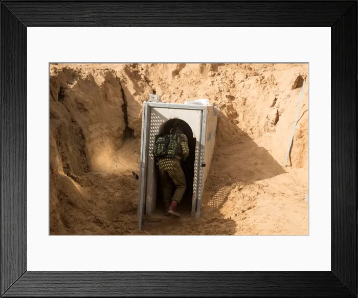 Framed Print : An Israeli soldier enters what the Israeli military say is a cross-border attack tunnel Framed Print : An Israeli soldier enters what the Israeli military say is a cross-border attack tunnel