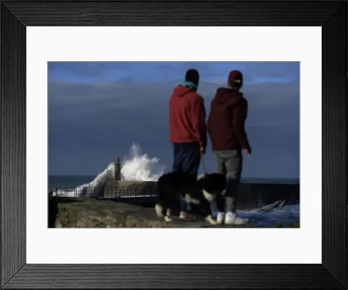 Framed Print : Two boys look at waves as they crash against a lighthouse in the port town of Viavelez Framed Print : Two boys look at waves as they crash against a lighthouse in the port town of Viavelez