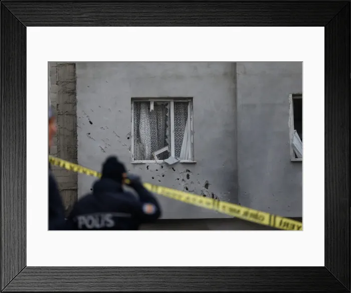 Framed Print : A policeman stands in front of a building which was damaged after a rocket fired Framed Print : A policeman stands in front of a building which was damaged after a rocket fired