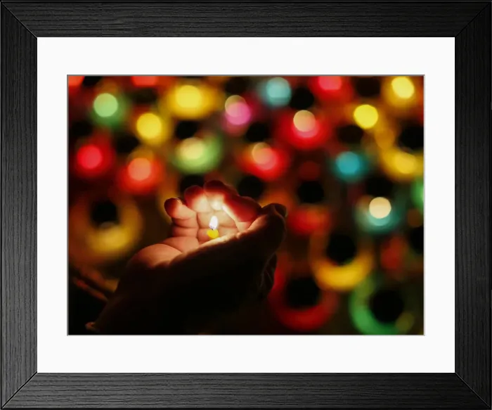 Framed Print : A woman holds a candle during a commemoration ceremony at a monument for Holodomor Framed Print : A woman holds a candle during a commemoration ceremony at a monument for Holodomor