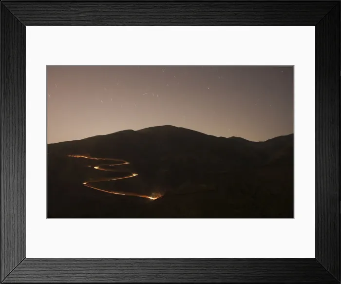 Framed Print : U. S. border patrol vehicle is seen from the Mexican side of the border while driving near