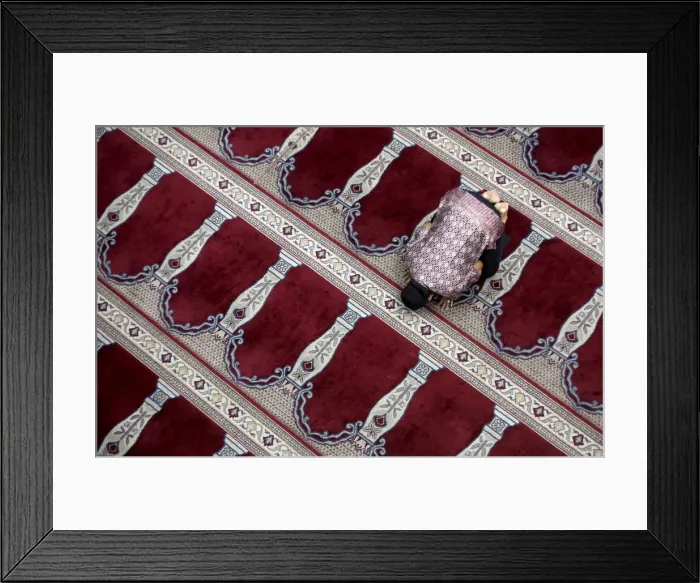 Framed Print : A man prays following Friday prayers at the Cut Meutia Mosque in Jakarta Framed Print : A man prays following Friday prayers at the Cut Meutia Mosque in Jakarta