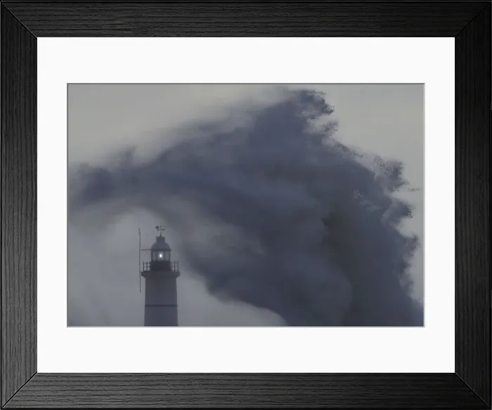Framed Print : Waves and high winds hit the sea wall and light beacon at Newhaven in south England Framed Print : Waves and high winds hit the sea wall and light beacon at Newhaven in south England