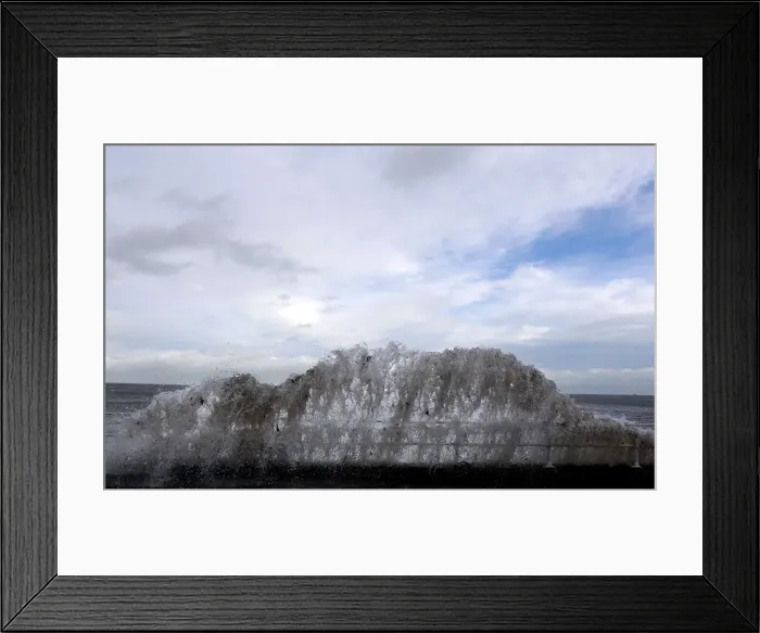 Framed Print : Waves crash against the coastal wall in the village of Carnlough as high tides Framed Print : Waves crash against the coastal wall in the village of Carnlough as high tides