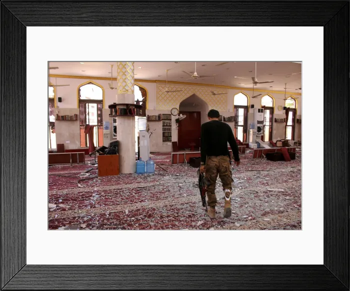 Framed Print : A member of security forces organized by the Saudi-led coalition inspects a mosque