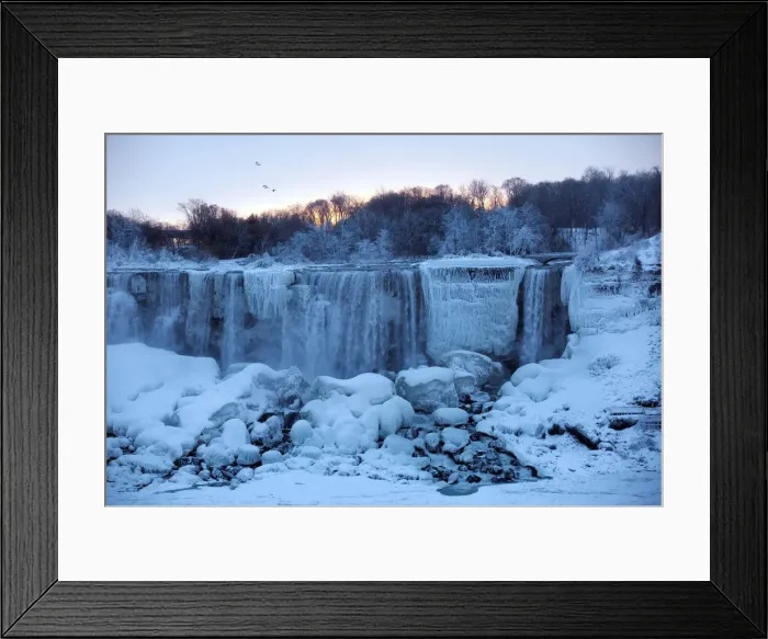 Framed Print : A group of birds fly past ice and water flowing over the American Falls