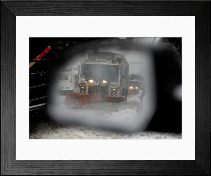 Framed Print : A snowplow is seen in a cars side mirror in upper Manhattan during Storm Grayson in New Framed Print : A snowplow is seen in a cars side mirror in upper Manhattan during Storm Grayson in New