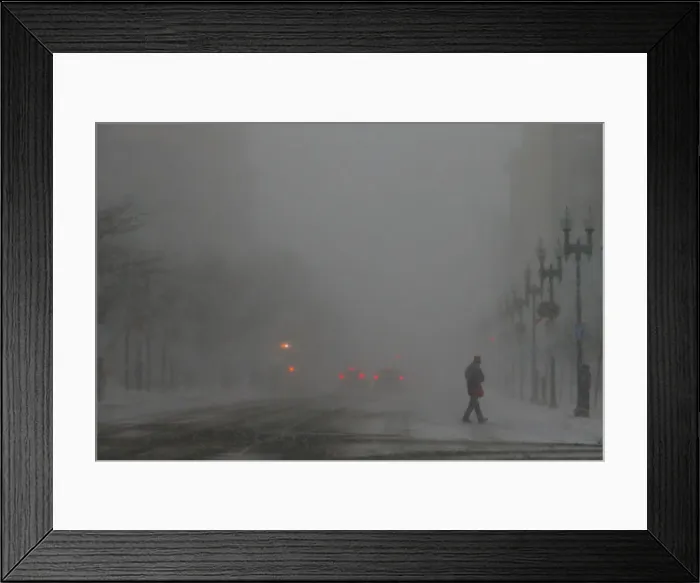 Framed Print : A pedestrian crosses Boylston Street during a winter snow storm in Boston