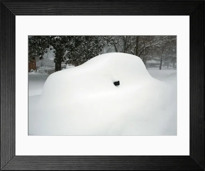 Framed Print : A mirror is all that can be seen of a snow covered car in Falls Church, Virginia