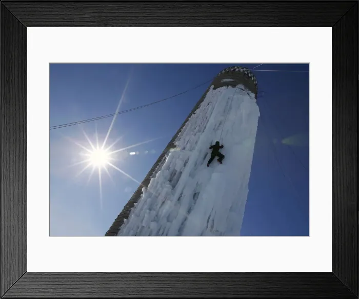 Framed Print : An climber ascends a silo covered in ice in Cedar Falls