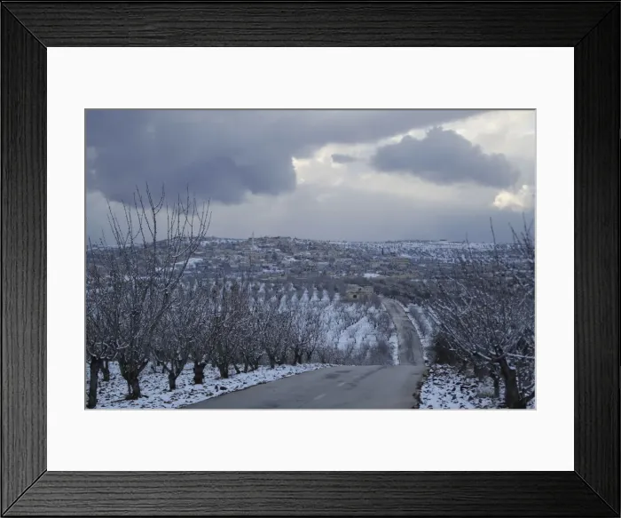 Framed Print : Snow covers a village in Jabal al-Zawiya, in the southern countryside of Idlib, Syria