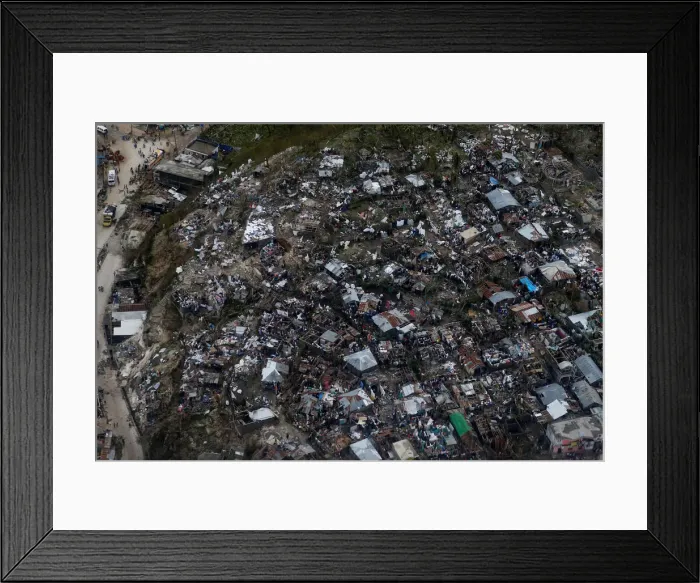 Framed Print : People wade through a flooded street and next to destroyed houses after Hurricane Matthew Framed Print : People wade through a flooded street and next to destroyed houses after Hurricane Matthew