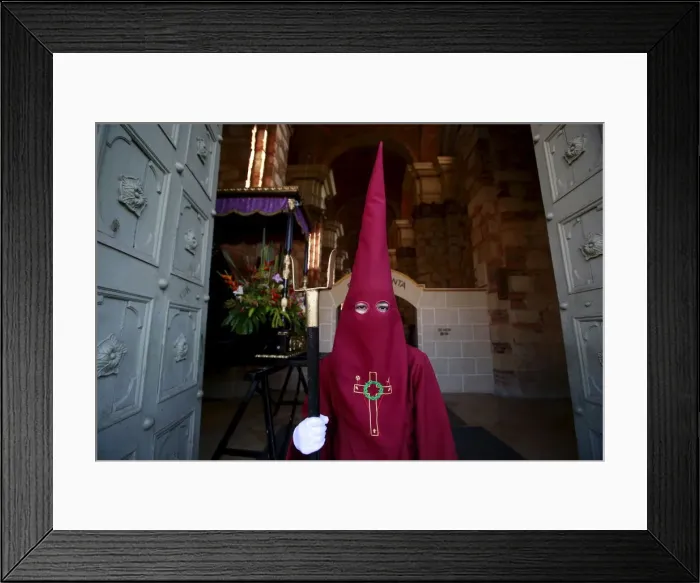 Framed Print : A member of the Nazarenos brotherhood takes part in a processsion on Good Friday in
