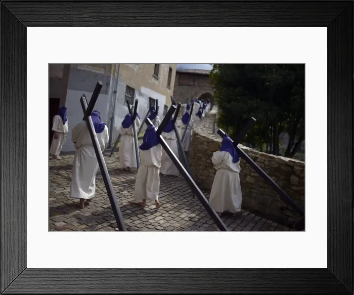 Framed Print : Residents dressed as penitents take part in an Easter Passion Play on Good Friday in