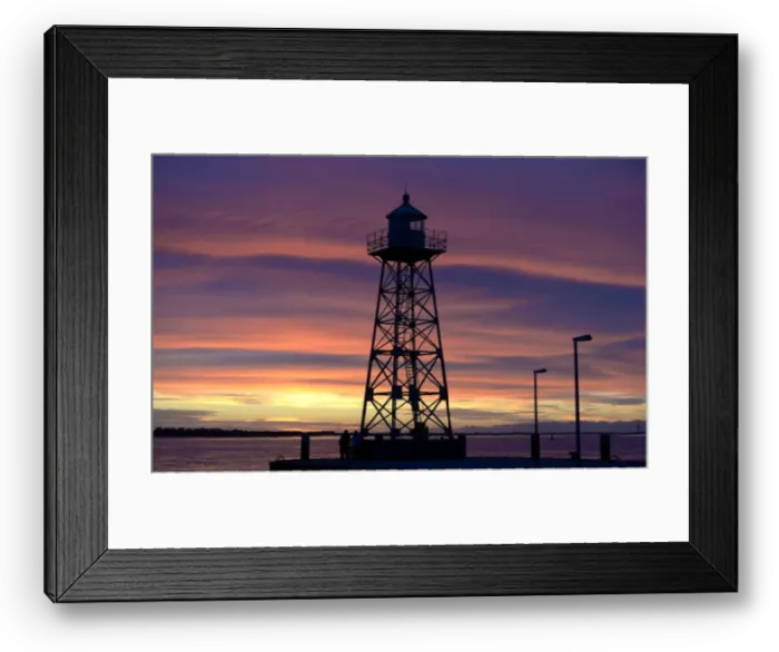 Framed Print : A couple stand beside a light house, which is silhouetted during sunset at the Weser Framed Print : A couple stand beside a light house, which is silhouetted during sunset at the Weser