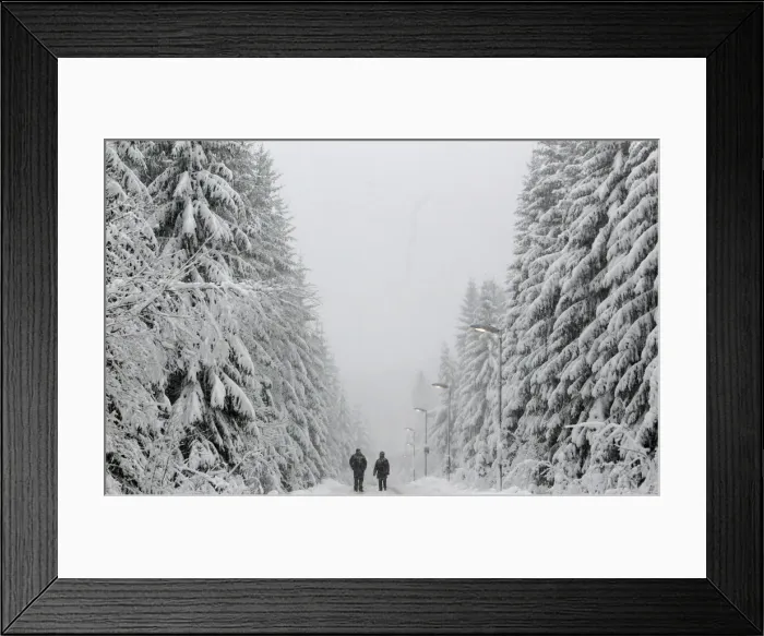 Framed Print : People walk under heavy snowfall near the eastern German town of Altenberg Framed Print : People walk under heavy snowfall near the eastern German town of Altenberg