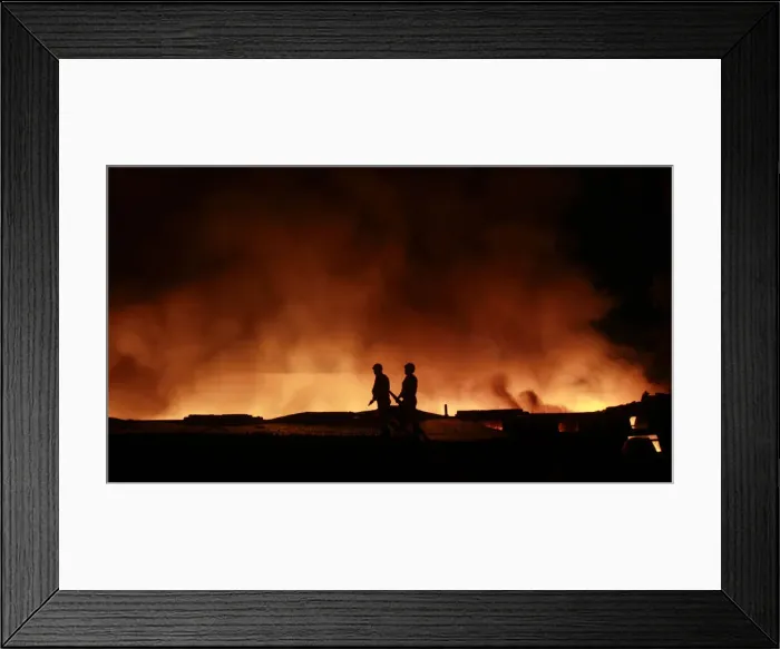 Framed Print : Firemen try to extinguish a fire that broke out in a rubber warehouse at Agartala