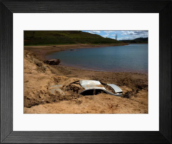 Framed Print : Cars suspected to be stolen and dumped in Jaguari lake appear on dry ground during a