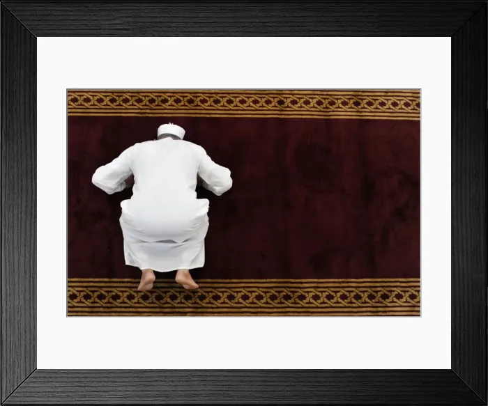 Framed Print : A man prays in a mosque in the old city, in Tripoli