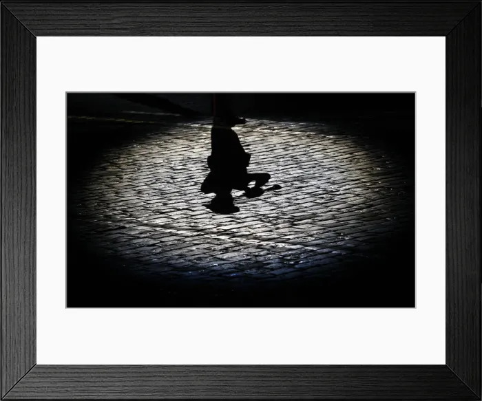Framed Print : The shadow of a participant is cast onto the ground during the International Military