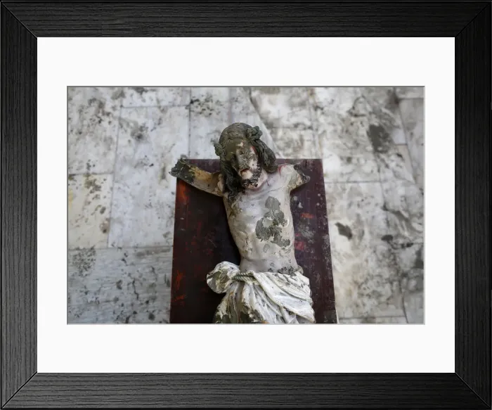 Framed Print : A damaged statue of Jesus Christ that was recovered from rubbles is placed in a church in Framed Print : A damaged statue of Jesus Christ that was recovered from rubbles is placed in a church in