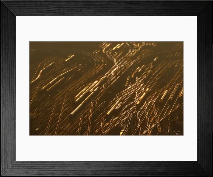Framed Print : Railway tracks lead towards the main train station as the sun sets on a freezing cold Framed Print : Railway tracks lead towards the main train station as the sun sets on a freezing cold
