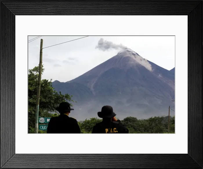 Framed Print : Police officers observe a lahar flowing down from the Fuego volcano at El Rodeo in