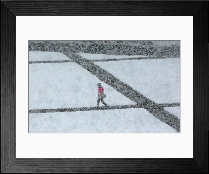 Framed Print : A pedestrian walks during a heavy snowfall in the Siberian town of Divnogorsk Framed Print : A pedestrian walks during a heavy snowfall in the Siberian town of Divnogorsk
