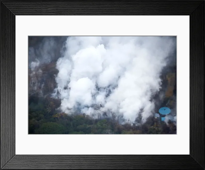 Framed Print : Smoke and steam rise from a lava flow in the Leilani Estates subdivision during ongoing