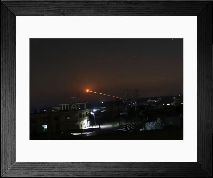 Framed Print : Missile fire is seen over Daraa