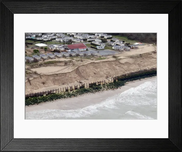 Framed Print : An aerial view shows sea walls on the beach that protect camping areas