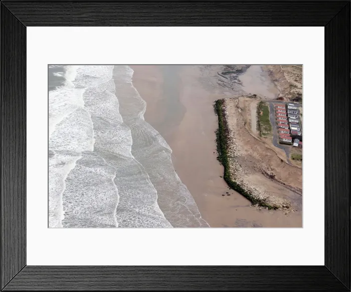 Framed Print : An aerial view shows a sea wall on the beach that protects camping sites Framed Print : An aerial view shows a sea wall on the beach that protects camping sites