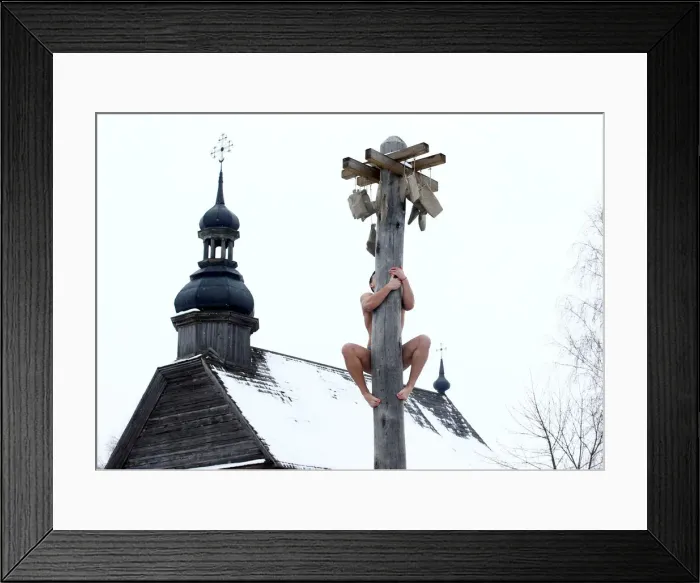 Framed Print : Man climbs up a wooden pole to get a prize during celebration of Maslenitsa Framed Print : Man climbs up a wooden pole to get a prize during celebration of Maslenitsa