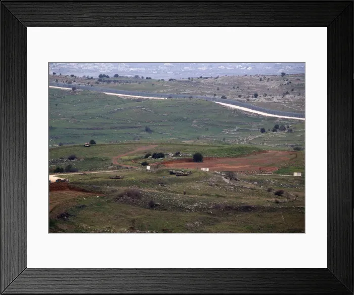 Framed Print : Military vehicles can be seen positioned on the Israeli side of the border with Syria Framed Print : Military vehicles can be seen positioned on the Israeli side of the border with Syria