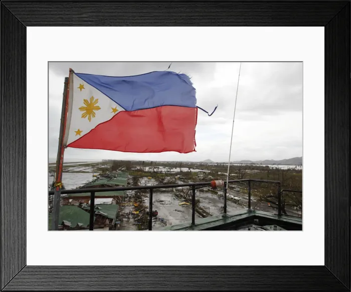 Framed Print : A Philippine flag flutters atop the control tower of a damaged airport after super Framed Print : A Philippine flag flutters atop the control tower of a damaged airport after super