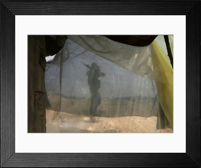 Framed Print : A Turkish-backed Free Syrian Army fighter carries his weapon as he walks on mount Framed Print : A Turkish-backed Free Syrian Army fighter carries his weapon as he walks on mount