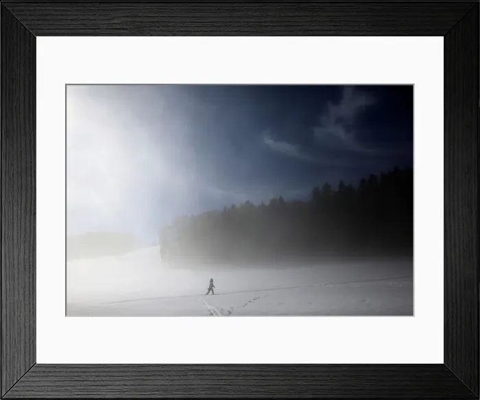 Framed Print : A woman crosses a field during a foggy morning in Bern