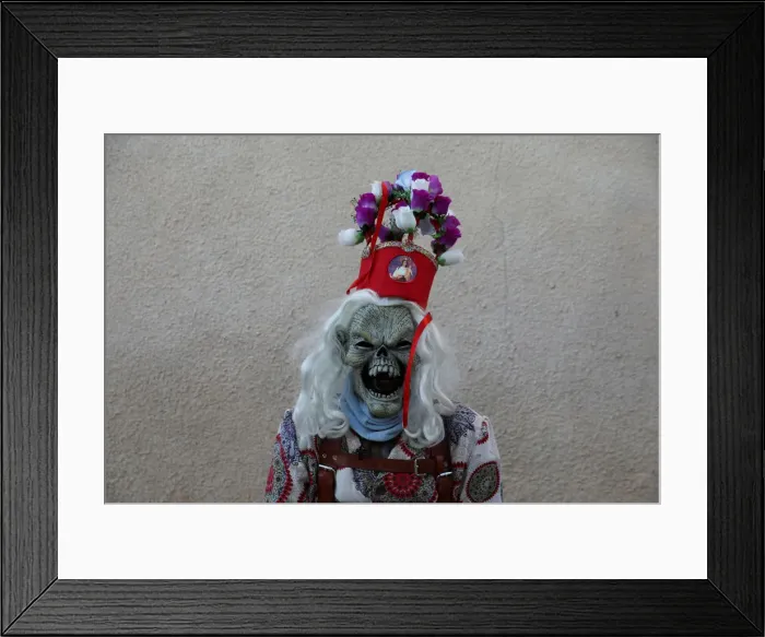 Framed Print : A believer dressed as a diablo (devil), poses during the Endiablada festival in Framed Print : A believer dressed as a diablo (devil), poses during the Endiablada festival in