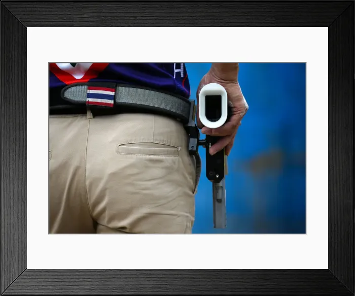 Framed Print : A man prepares to shoot during a practice session at a shooting range in Bangkok Framed Print : A man prepares to shoot during a practice session at a shooting range in Bangkok