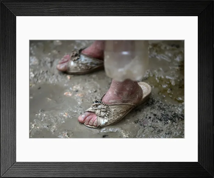 Framed Print : An internally displaced Syrian girl stands in the mud after heavy rain at a camp on Framed Print : An internally displaced Syrian girl stands in the mud after heavy rain at a camp on